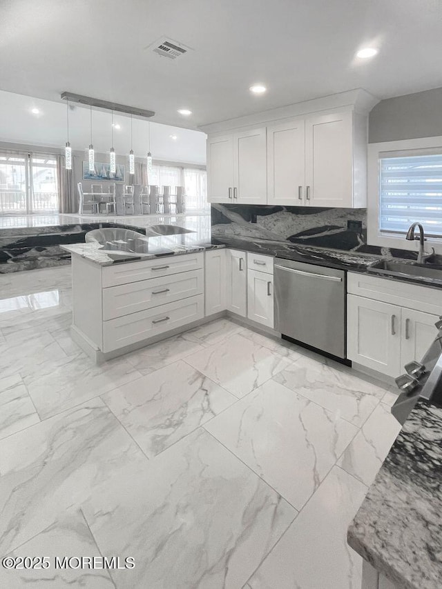 177 N Ensign Dr, Little Egg Harbor, NJ 08087 - kitchen with stainless steel dishwasher, white cabinets, tasteful backsplash, a peninsula, and light marble finish floors