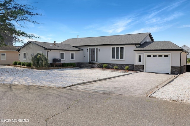 177 N Ensign Dr, Little Egg Harbor, NJ 08087 - single story home featuring stucco siding, a garage, decorative driveway, and stone siding