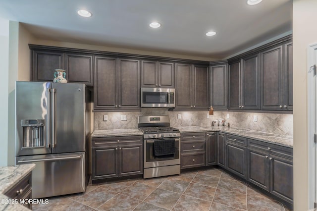 51 Galley Way, Little Egg Harbor, NJ 08087 - kitchen with stainless steel appliances, dark brown cabinets, light stone countertops, backsplash, and recessed lighting