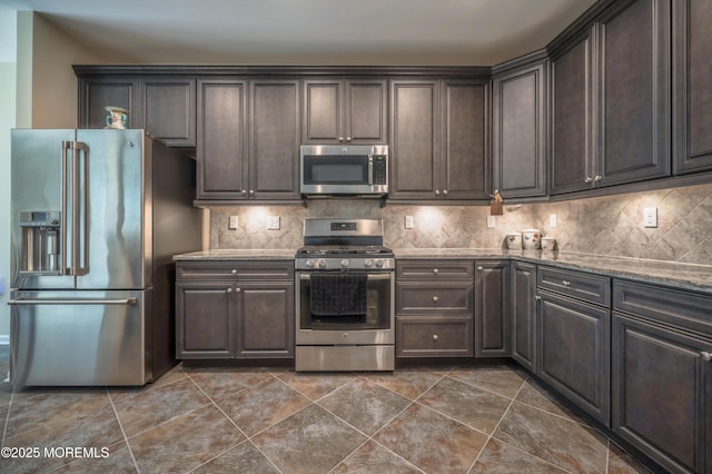 51 Galley Way, Little Egg Harbor, NJ 08087 - kitchen with stainless steel appliances, dark brown cabinetry, light stone countertops, and tasteful backsplash
