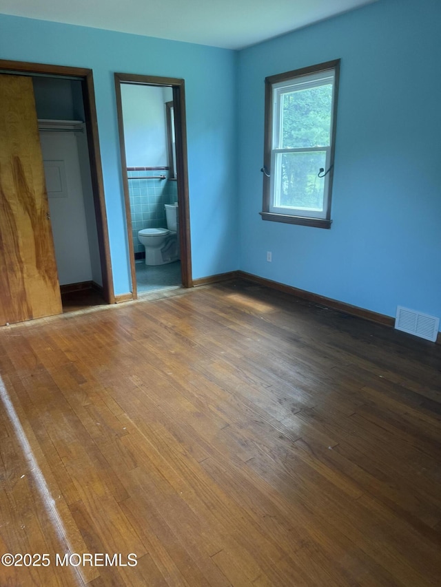 132 Harrison Ave, Fair Haven, NJ 07704 - unfurnished bedroom featuring wood finished floors, a closet, and ensuite bath