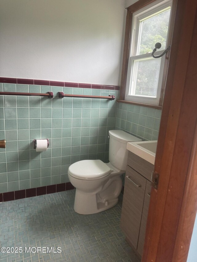 132 Harrison Ave, Fair Haven, NJ 07704 - half bathroom featuring vanity, tile walls, wainscoting, and tile patterned flooring