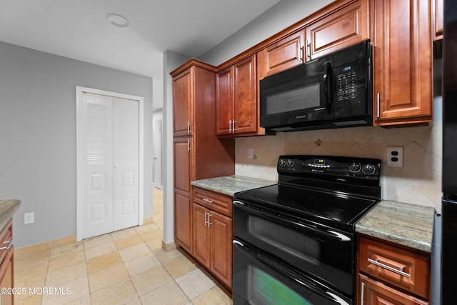 229 Medford Ct Unit B, Manalapan, NJ 07726 - kitchen with black appliances, tasteful backsplash, light stone counters, and brown cabinetry