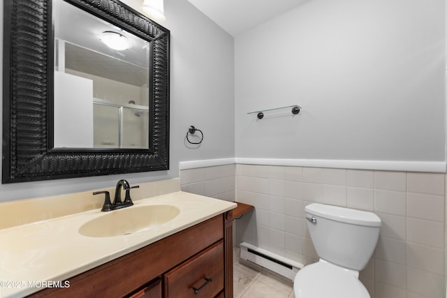 229 Medford Ct Unit B, Manalapan, NJ 07726 - bathroom with a baseboard heating unit, vanity, a shower with shower door, a wainscoted wall, and tile walls