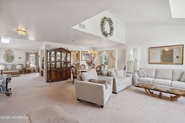 9 Penny Ln, Jackson, NJ 08527 - living area with light carpet, a chandelier, a skylight, and high vaulted ceiling