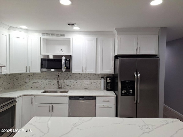 77 E Water St Unit 12, Toms River, NJ 08753 - kitchen featuring appliances with stainless steel finishes, open shelves, white cabinets, tasteful backsplash, and light stone counters