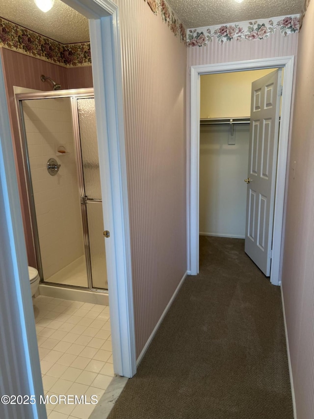 2 Mayapple Dr, Brick, NJ 08724 - hallway featuring a textured ceiling, light tile patterned flooring, wallpapered walls, and light colored carpet