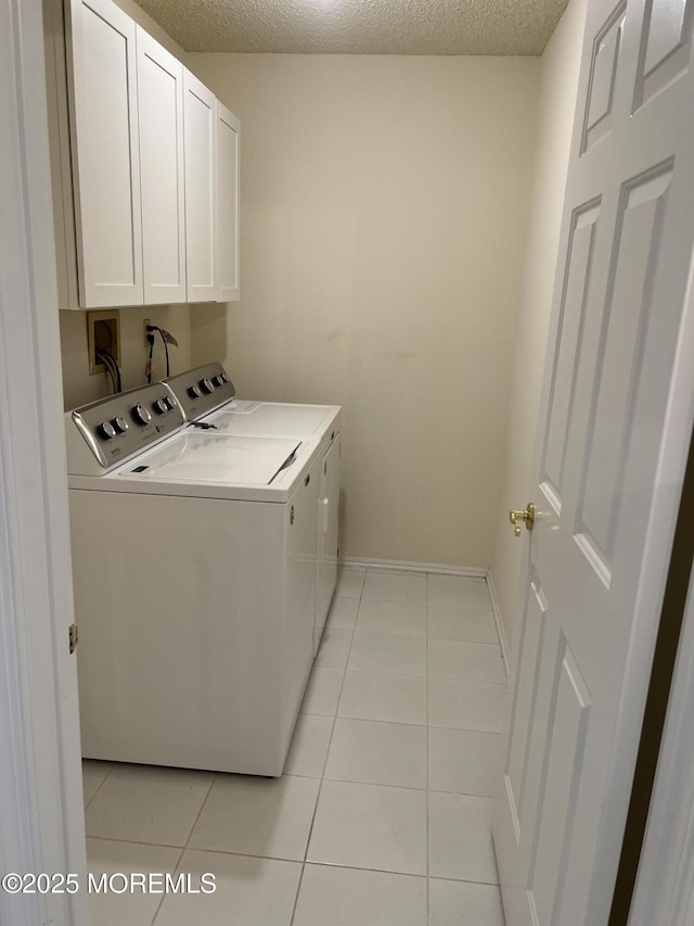 2 Mayapple Dr, Brick, NJ 08724 - laundry area featuring separate washer and dryer, cabinet space, light tile patterned flooring, and a textured ceiling