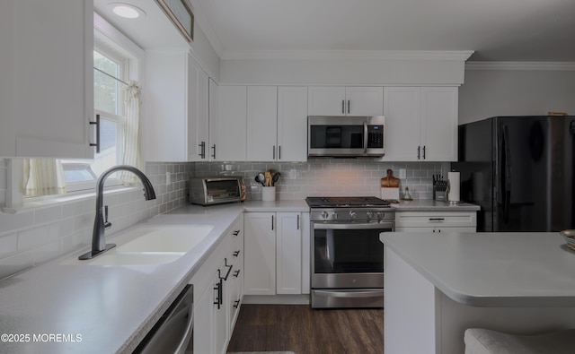 1113 Pemberton St, Toms River, NJ 08757 - kitchen with appliances with stainless steel finishes, light countertops, dark wood-type flooring, backsplash, and white cabinetry