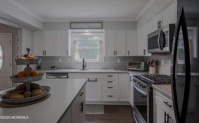 1113 Pemberton St, Toms River, NJ 08757 - kitchen with stainless steel appliances, dark wood-style flooring, crown molding, white cabinets, and light countertops