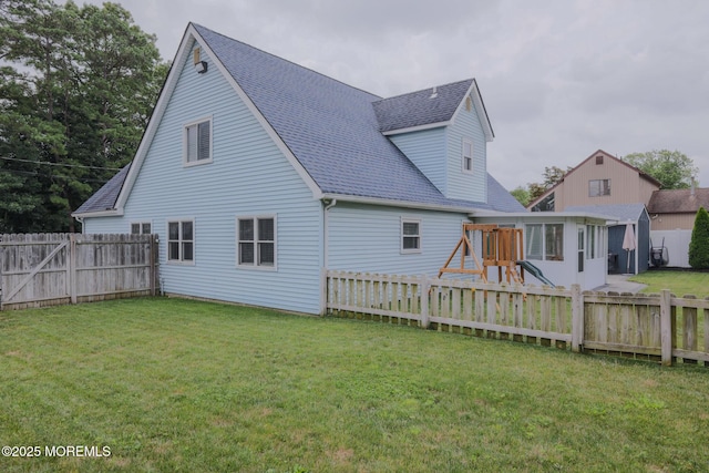 1113 Pemberton St, Toms River, NJ 08757 - rear view of property featuring a shingled roof, a fenced backyard, and a playground