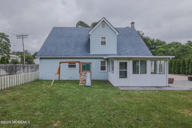 1113 Pemberton St, Toms River, NJ 08757 - back of property featuring a chimney, a shingled roof, a playground, and a patio area