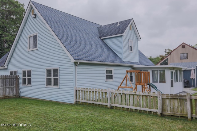 1113 Pemberton St, Toms River, NJ 08757 - back of property with a shingled roof, a playground, and a fenced backyard