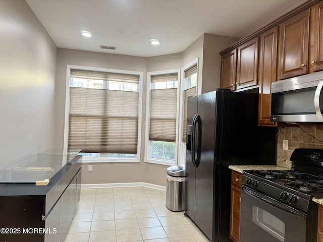 2116 Edward Stec Blvd Unit 2116, Edison, NJ 08837 - kitchen with stainless steel microwave, gas stove, plenty of natural light, tasteful backsplash, and recessed lighting