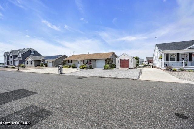803 Wave Dr, Forked River, NJ 08731 - view of front of property featuring a residential view, concrete driveway, an attached garage, and a storage unit