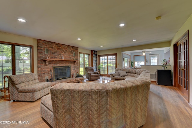 26 Old Manor Rd, Holmdel, NJ 07733 - living room with light wood-style flooring, a brick fireplace, plenty of natural light, and recessed lighting