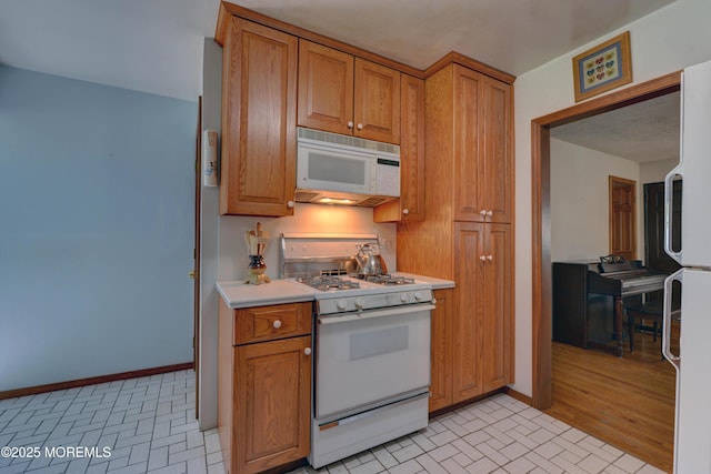 26 Old Manor Rd, Holmdel, NJ 07733 - kitchen with white appliances, brown cabinets, and light countertops
