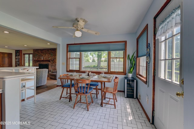 26 Old Manor Rd, Holmdel, NJ 07733 - dining space featuring wine cooler, a fireplace, a ceiling fan, brick patterned flooring, and recessed lighting