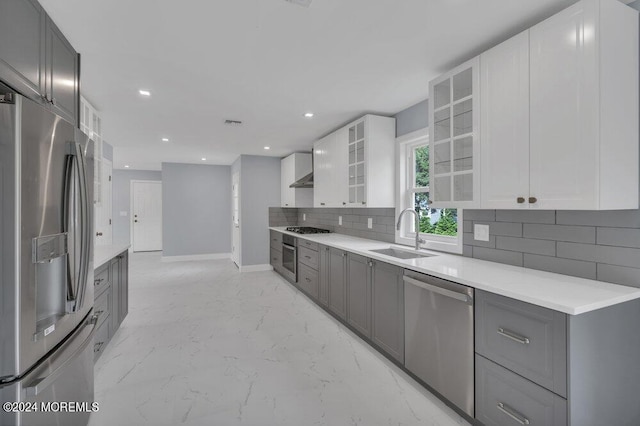 166 Montrose Rd, Colts Neck, NJ 07722 - kitchen featuring stainless steel appliances, gray cabinets, tasteful backsplash, glass insert cabinets, and light marble finish floors