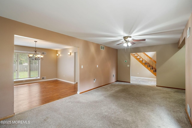 424 Continental St, Forked River, NJ 08731 - unfurnished living room with carpet flooring, a chandelier, a ceiling fan, and stairs