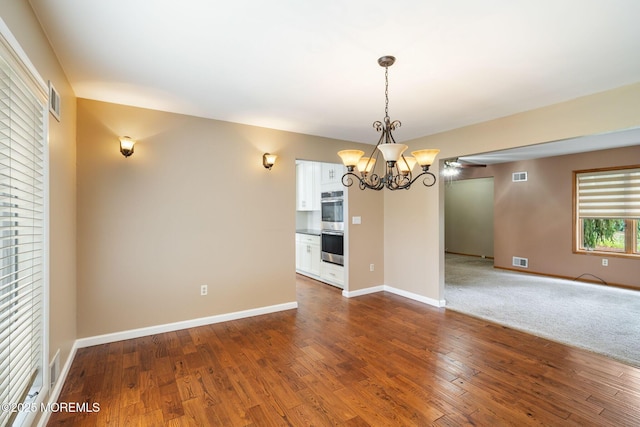 424 Continental St, Forked River, NJ 08731 - unfurnished dining area featuring a chandelier, dark wood-style flooring, and ceiling fan
