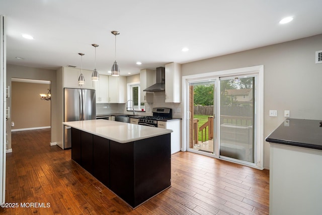 424 Continental St, Forked River, NJ 08731 - kitchen featuring stainless steel appliances, wall chimney range hood, backsplash, white cabinets, and dark wood-style floors