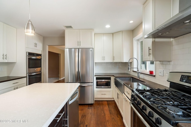 424 Continental St, Forked River, NJ 08731 - kitchen featuring appliances with stainless steel finishes, extractor fan, dark wood-style flooring, recessed lighting, and decorative backsplash