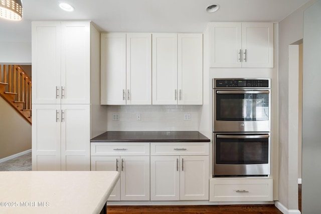 424 Continental St, Forked River, NJ 08731 - kitchen with stainless steel double oven, white cabinets, recessed lighting, decorative backsplash, and dark countertops