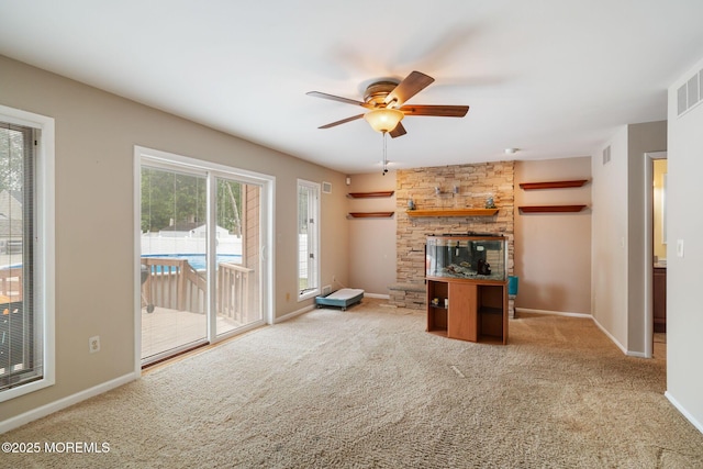 424 Continental St, Forked River, NJ 08731 - unfurnished living room featuring healthy amount of natural light, ceiling fan, carpet flooring, and a stone fireplace