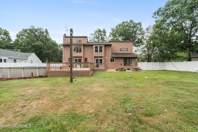 424 Continental St, Forked River, NJ 08731 - back of house featuring a fenced backyard, an outdoor fire pit, a deck, and a chimney