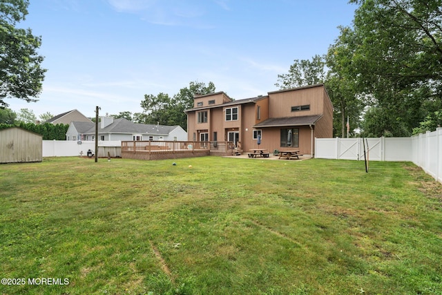 424 Continental St, Forked River, NJ 08731 - back of property with a fenced backyard, a fire pit, a shed, and a wooden deck