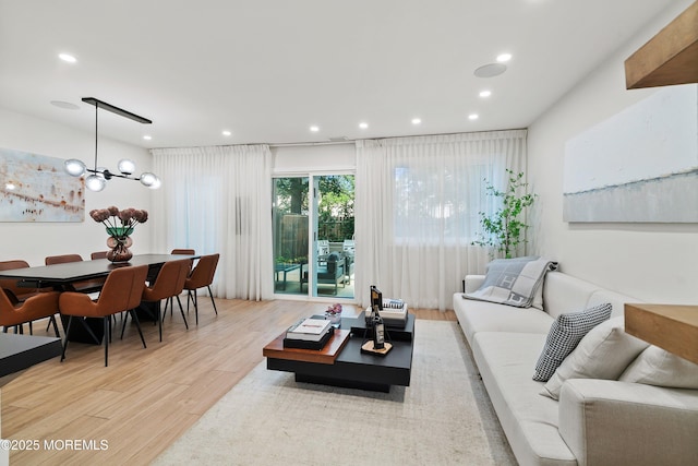 144 Colony Cir, Lakewood, NJ 08701 - living room with light wood-type flooring, recessed lighting, and a chandelier