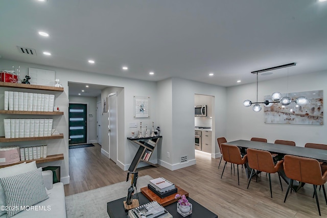 144 Colony Cir, Lakewood, NJ 08701 - living area with wood finished floors, recessed lighting, and a chandelier
