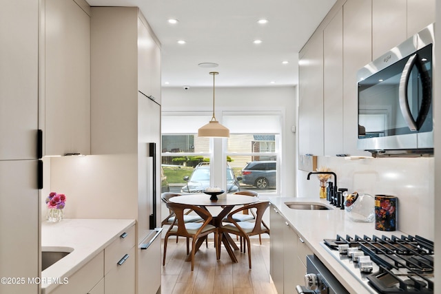 144 Colony Cir, Lakewood, NJ 08701 - kitchen featuring stainless steel appliances, modern cabinets, recessed lighting, light stone counters, and decorative light fixtures