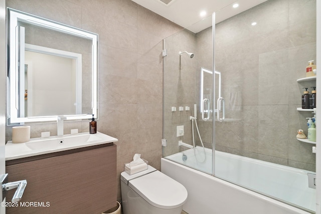 144 Colony Cir, Lakewood, NJ 08701 - full bathroom featuring vanity, enclosed tub / shower combo, and tile walls