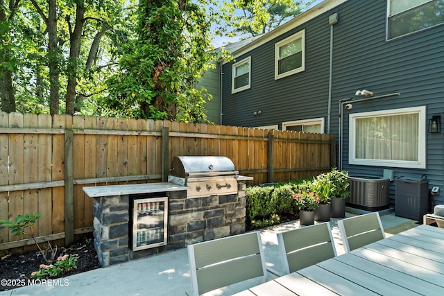 144 Colony Cir, Lakewood, NJ 08701 - view of patio / terrace featuring an outdoor kitchen, wine cooler, and outdoor dining space