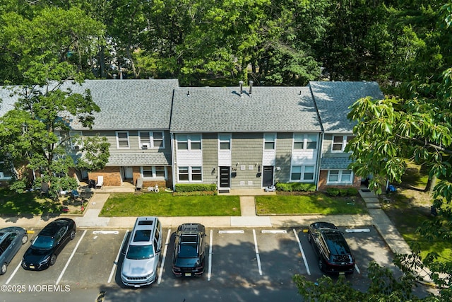 144 Colony Cir, Lakewood, NJ 08701 - view of front of house with uncovered parking and a shingled roof
