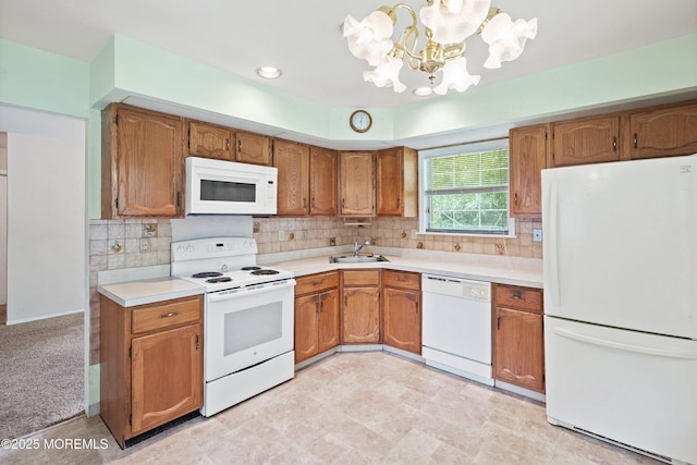 153D Concordia Cir, Monroe, NJ 08831 - kitchen with white appliances, a chandelier, light countertops, brown cabinets, and tasteful backsplash