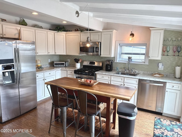 57 Albert Dr, Beach Haven West, NJ 08050 - kitchen featuring stainless steel appliances, beamed ceiling, tasteful backsplash, wood finished floors, and white cabinetry