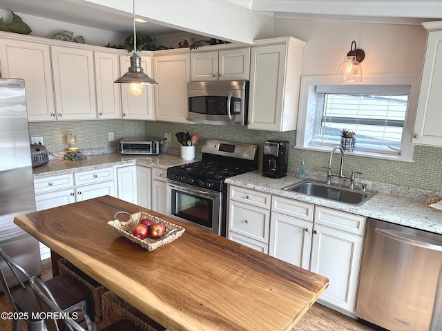 57 Albert Dr, Beach Haven West, NJ 08050 - kitchen with appliances with stainless steel finishes, white cabinetry, decorative backsplash, and hanging light fixtures