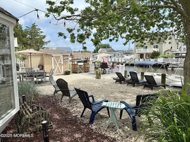 57 Albert Dr, Beach Haven West, NJ 08050 - view of home's community with a shed, outdoor dining area, and a residential view