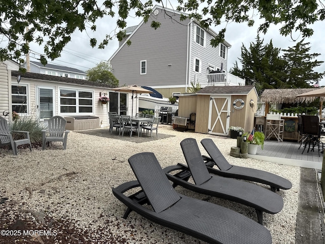 57 Albert Dr, Beach Haven West, NJ 08050 - back of property with a wooden deck, outdoor dining area, and a storage shed