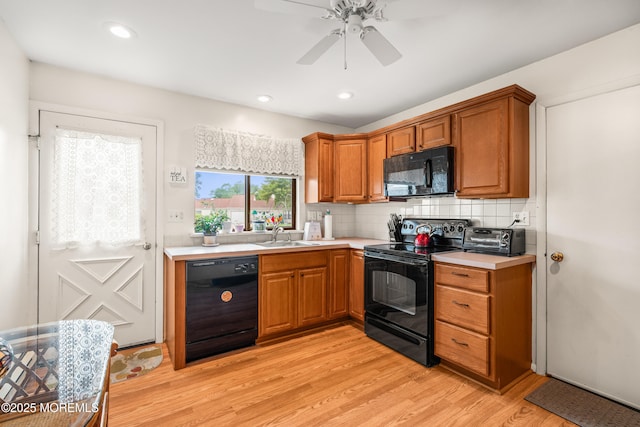628A Stamford Ct, Manchester, NJ 08759 - kitchen with black appliances, light wood-style floors, light countertops, brown cabinetry, and decorative backsplash