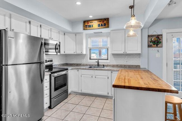 202 Lincoln Ave Unit C5, Seaside Heights, NJ 08751 - kitchen featuring appliances with stainless steel finishes, a peninsula, white cabinetry, decorative backsplash, and recessed lighting