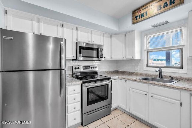 202 Lincoln Ave Unit C5, Seaside Heights, NJ 08751 - kitchen with stainless steel appliances, white cabinets, light tile patterned flooring, and backsplash