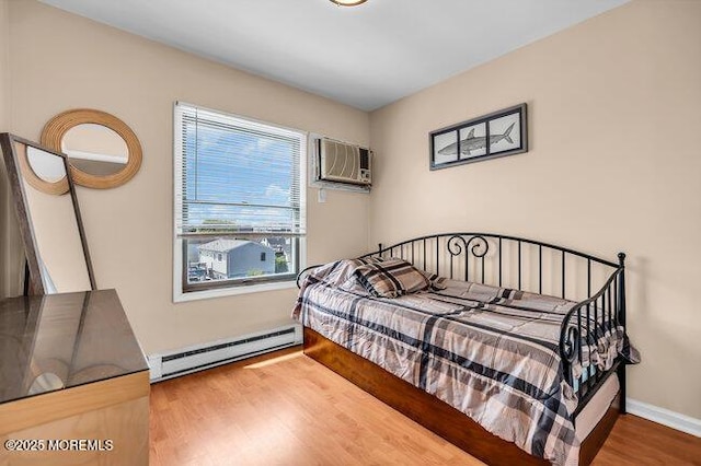 202 Lincoln Ave Unit C5, Seaside Heights, NJ 08751 - bedroom featuring baseboard heating, wood finished floors, and a wall mounted air conditioner