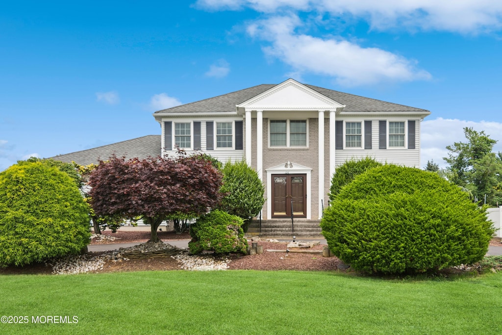 126 Wyncrest Rd, Marlboro, NJ 07746 - greek revival inspired property with a front lawn and a shingled roof