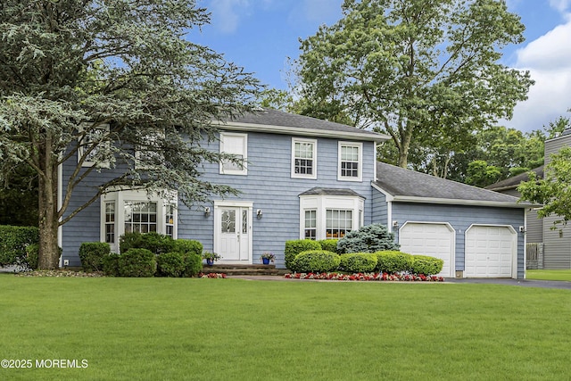 16 Bridge Ct, Jackson, NJ 08527 - colonial house with an attached garage, a front yard, asphalt driveway, and a shingled roof