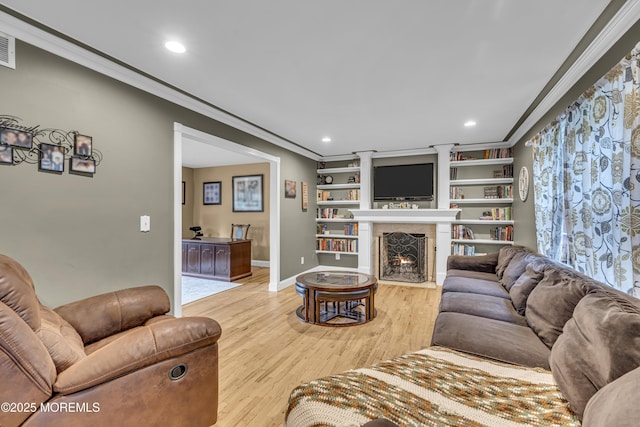 16 Bridge Ct, Jackson, NJ 08527 - living area with ornamental molding, light wood-style flooring, a warm lit fireplace, and recessed lighting
