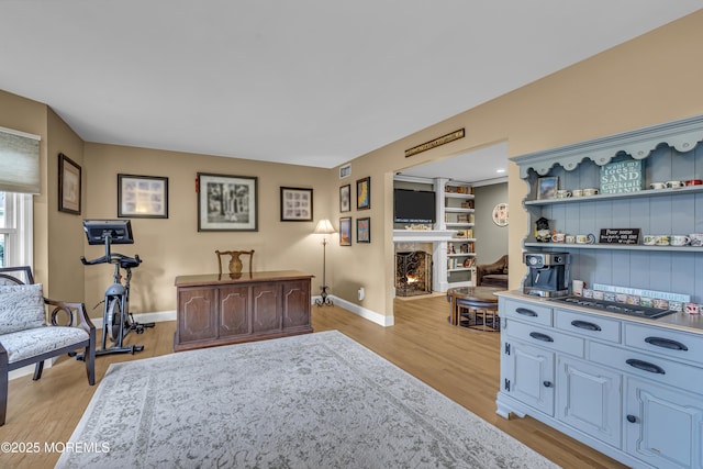 16 Bridge Ct, Jackson, NJ 08527 - living area with light wood-style floors and a warm lit fireplace